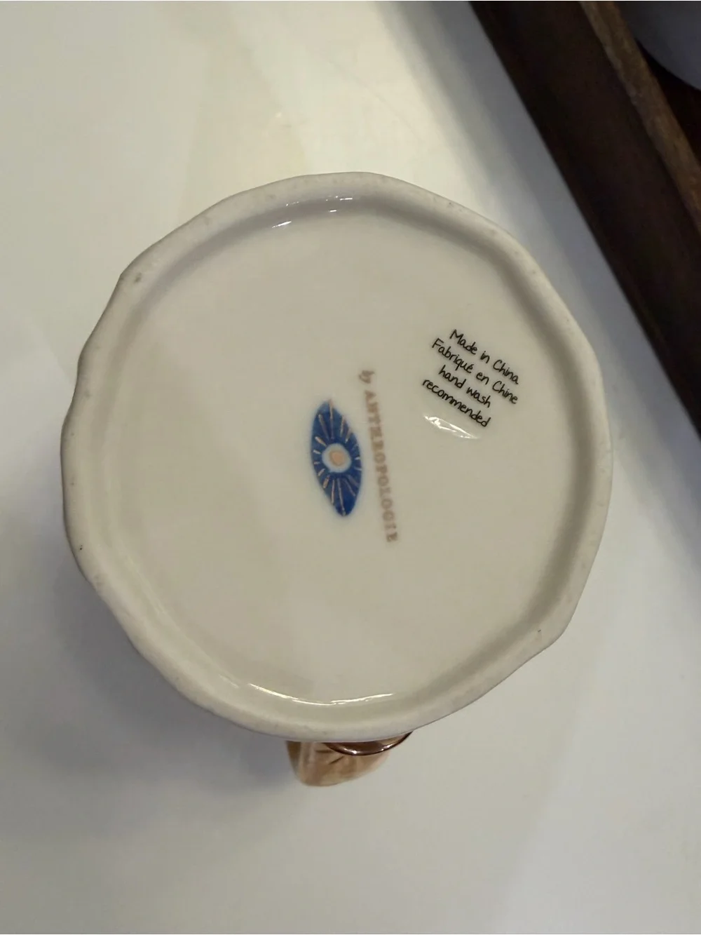 Anthropologie White Ceramic Mug with Blue Eye Motif and Gold Trim